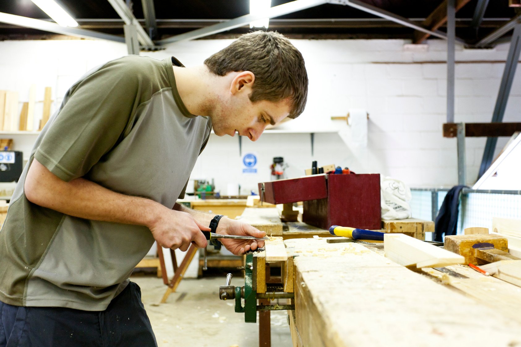 Boat builder using a chisel